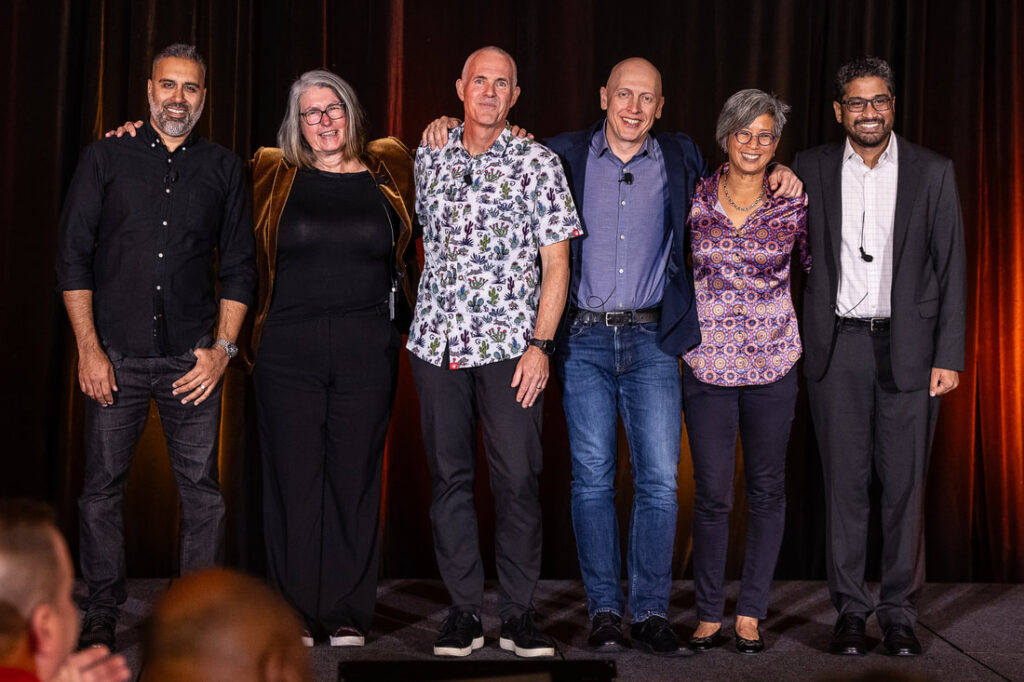 group of TAG members standing on stage